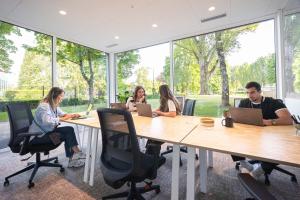 a group of people sitting around a table with laptops at Babel Community Hôtel Lille - Villeneuve d'Ascq in Villeneuve d'Ascq +77 photos