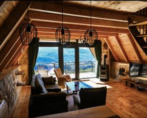a living room with a view of a mountain at Chalet Highland in Plužine +14 photos