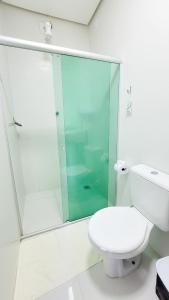 a bathroom with a toilet and a glass shower at Pousada e Suítes Ecologia Lençóis in Lençóis +27 photos