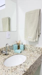 a bathroom counter with a sink and a mirror at Pousada e Suítes Ecologia Lençóis in Lençóis +52 photos