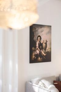 a painting of a girl with a goat on a wall at wyciszy i ukoi apartament - w najpiękniejszej dzielnicy Katowic in Katowice