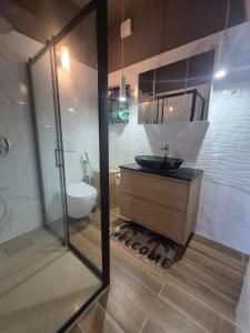 a bathroom with a sink and a toilet and a mirror at Sunset House in Costa Paradiso