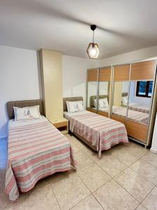 a hotel room with two beds and a mirror at aura residence in Bodrum City +35 photos