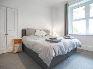 a bedroom with a bed with towels on it at Oak - Uk38687 in Bideford