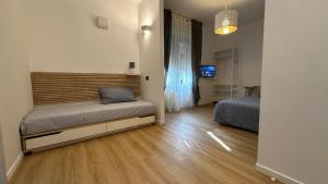 a bedroom with two beds in a room at Foresteria Green House 2 in Seriate