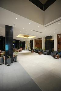 a large lobby with couches and tables and a lobby at Al jadriya Palace in Baghdad