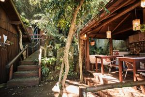 a patio with a table and a tree at Pousada Amô in Guarda do Embaú