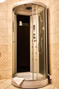 a shower with a glass door in a bathroom at Hotel Racibor in Racibórz