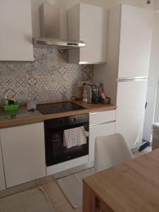 a kitchen with white cabinets and a stove top oven at White Moon in Fontane Bianche +12 photos