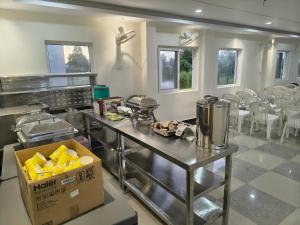 a kitchen with a counter with a box of food at 7Sky Hotel and Restaurant in Bhojpur