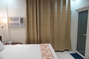 a bedroom with a bed and a window at 7Sky Hotel and Restaurant in Bhojpur +16 photos