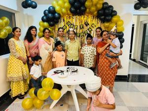 a group of people standing around a table with balloons at 7Sky Hotel and Restaurant in Bhojpur