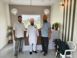 a group of three men standing in a room at 7Sky Hotel and Restaurant in Bhojpur