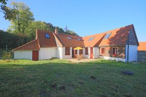 a house with orange roofs and a yard at Mouchette - Avec grand jardin in Créquy