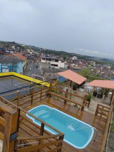 a hot tub on a deck with a view of a city at Nova Amsterdam aluga eventos in Guarulhos