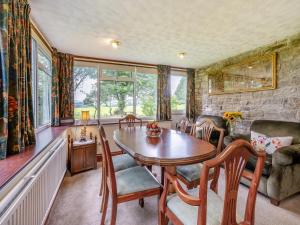 a dining room with a table and chairs at Steep Holm in Kington