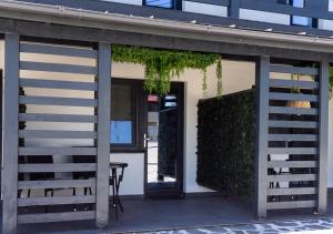 a building with a door and a chair in front at Lizubert in Afumaţi