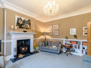 a living room with a chair and a fireplace at Temple House in West Burton