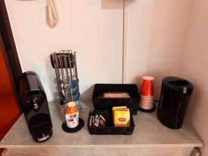 a counter top with a coffee maker and other items at Del Console Apartment - Near Bari Airport & Station in Modugno