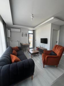 a living room with a couch and two chairs at Lighthouse Suite in Atakum