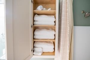 a closet with folded towels and towels at The Golden Tiger in Baton Rouge +45 photos