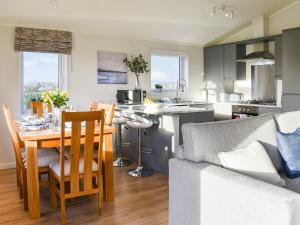a kitchen and living room with a table and a couch at The View - Uk36812 in Whalley
