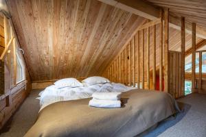 a bedroom with a bed in a wooden room at Huttopia La Clarée in Val-des-Prés