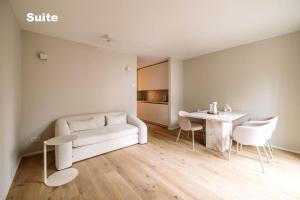 a living room with a white couch and a table at Lindgold in Munich +33 photos