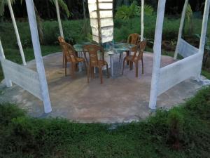 a table and chairs sitting on a patio at Good Vibes Homestay-Honnavar in Honāvar