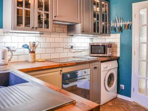 a kitchen with a washing machine and a washer at The Sandpiper in Filey