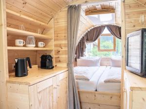 a bed in a tiny house with a window at Übernachten im Weinfass in Volkach