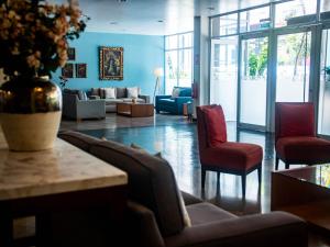 a lobby with couches and chairs and a vase at San Agustin Exclusive in Lima
