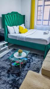 a living room with a bed and a coffee table at Studio 107,Sana Sana, South B, Off Mombasa Road in Nairobi