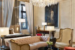 a living room with a couch and a chandelier at H15 Palace, a Luxury Collection Hotel, Krakow in Kraków