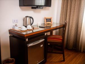 a kitchen counter with a coffee maker on top of it at San Agustin Exclusive in Lima +33 photos