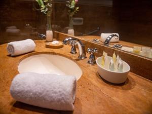 a bathroom sink with a white towel on it at San Agustin Exclusive in Lima