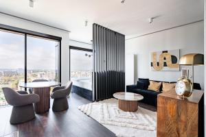 a living room with a couch and a table and chairs at J&K Towarowa Towers in Warsaw