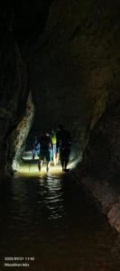 TimbanglawangBatu Katak - Zoey's Homestay的一群人穿过一个洞穴 更多1张照片