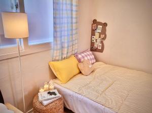 a small childs bedroom with a bed with a lamp at Candy stay#Parking#Up to 7 people#Suwon Haenggung Palace#KT Wiz#Starfield#Traditional Market#Washing and Drying in Suwon
