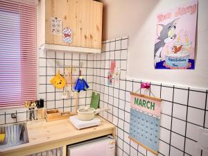 a kitchen with a counter with a cake on the wall at Candy stay#Parking#Up to 7 people#Suwon Haenggung Palace#KT Wiz#Starfield#Traditional Market#Washing and Drying in Suwon