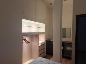 a bedroom with white cabinets and a bed in it at Vivas House in Esposende