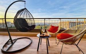 a balcony with hammocks and a table and chairs at Sunset Escape Apartment - panoramic terrace in Fiumicino
