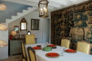 a dining room with a white table and chairs at Perche King's Bedroom in MaisonNomadeChic in Cour-Maugis-sur-Huisne
