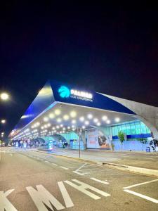 a building with a sign on it at night at Perto do aeroporto, estádio e Praia dos Buritis in Palmas +19 photos