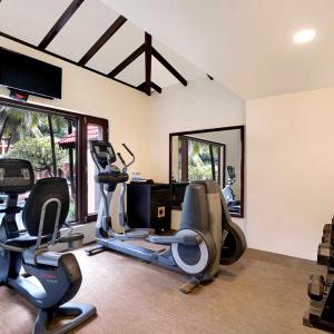 a gym with treadmills and ellipticals in a room at Hotel Euro Star Alikara suite in New Delhi