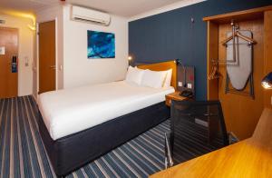 a bedroom with a large bed in a room at Holiday Inn Express London Chingford by IHG in London +60 photos