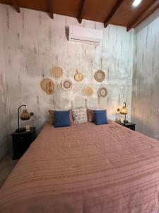 a bedroom with a large bed with blue pillows at Private Paradise El Tunco Villa OYA no 1 with private pool in El Sunzal +52 photos