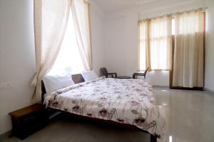 a bedroom with a bed and a window at Narayani Bag Resort & Restaurant 
