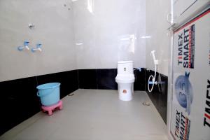 a bathroom with a toilet and a bucket in it at Narayani Bag Resort & Restaurant  +11 photos
