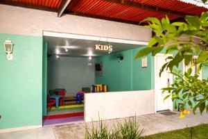 a childrens playroom with a kids sign on the wall at Scenarium Hotel in Recife